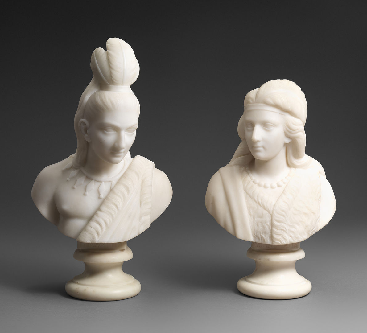 Two marble busts of Native American figures, Minnehaha and Hiawatha.