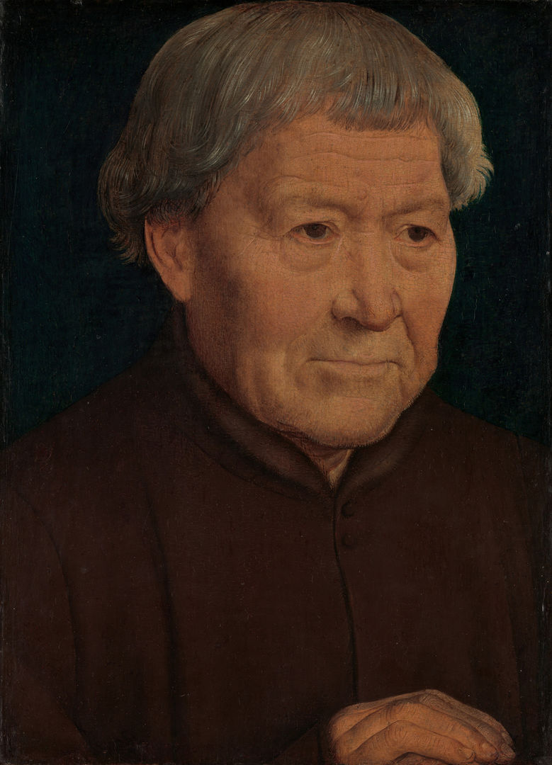 Portrait of an old man in a simple brown tunic with fur trim. His hands are placed over each other in the bottom right corner of the frame.