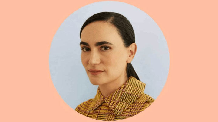 Portrait of Frida Escobado with a salmon pink background