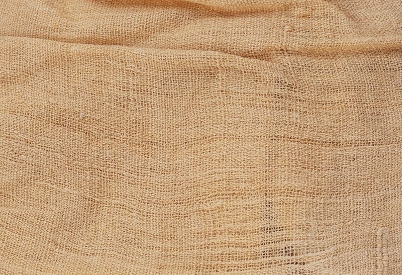 Close-up detail of a sheet of tan linen cloth