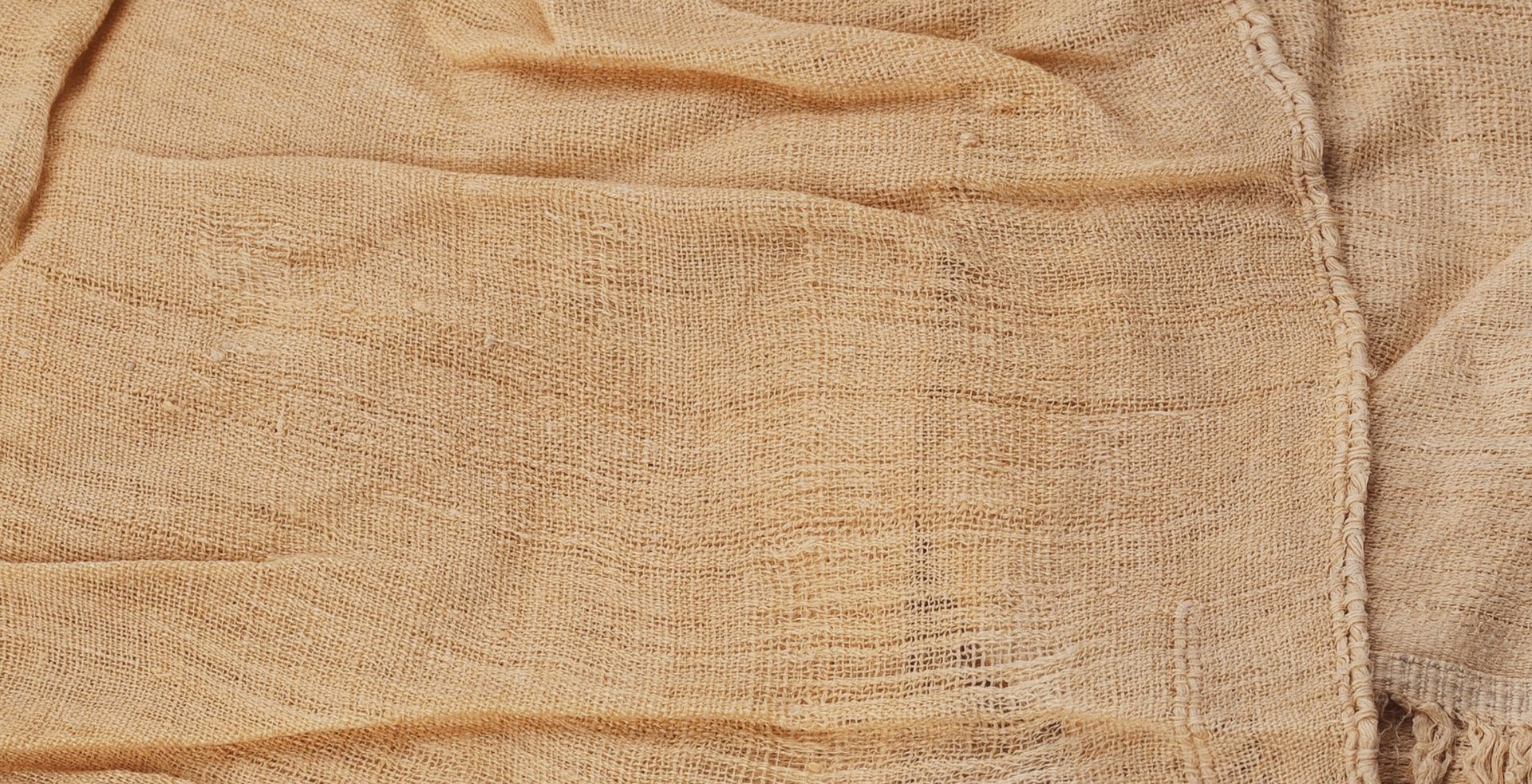 Close-up detail of a sheet of tan linen cloth