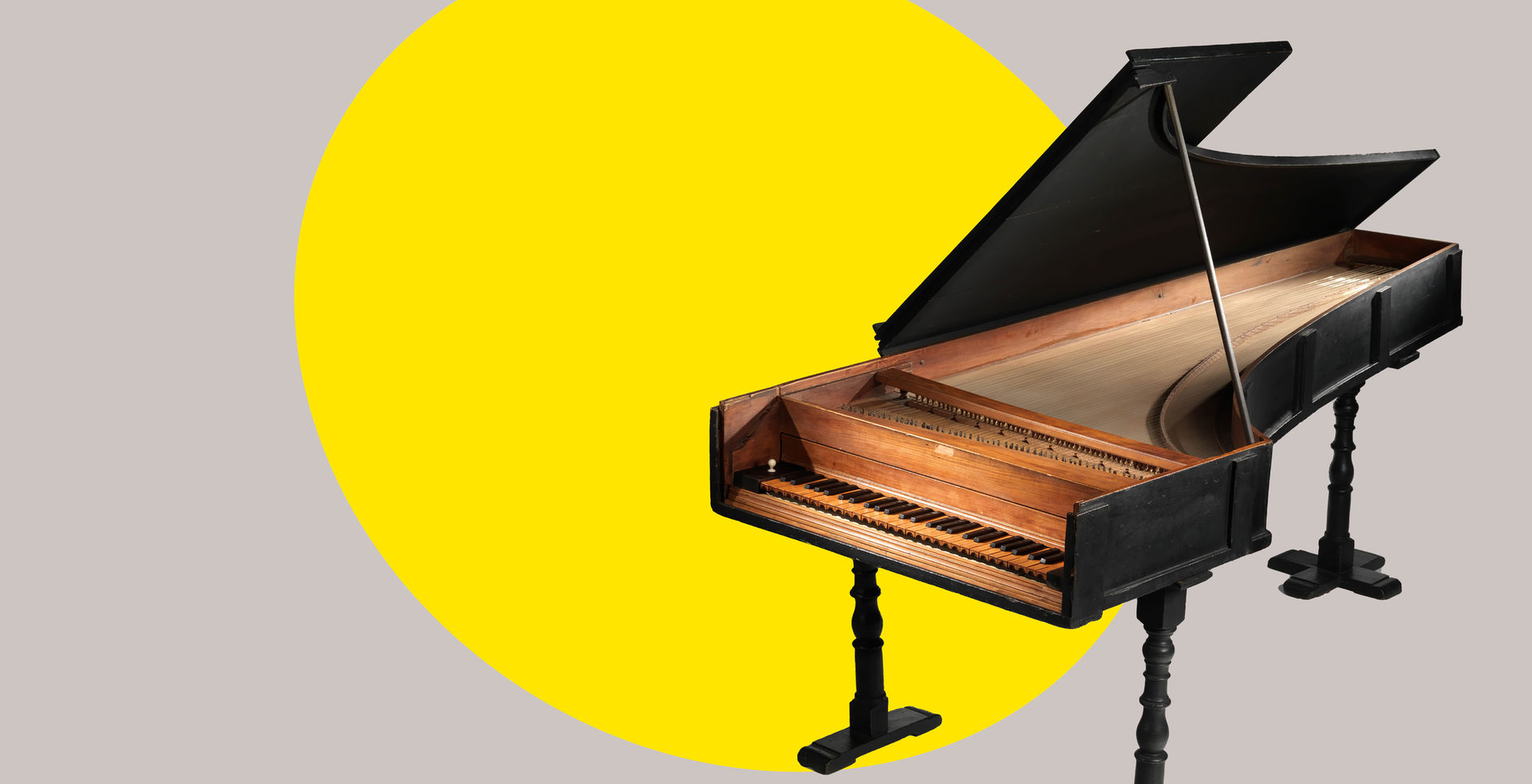 18th-century piano with a bright yellow ovular spotlight shape behind the figure in the background