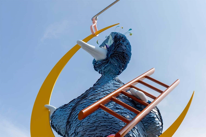 A blue Big Bird looks off into the distance