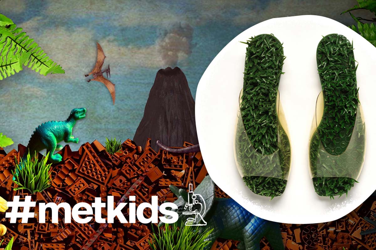 A collage made from legos and small toys of dinosaurs in a valley beneath a volcano, beside an inset photograph of clear plastic sandals with fake grass sprouting from the insole. Bottom text reads hashtag MetKids and an icon indicating a microscope.