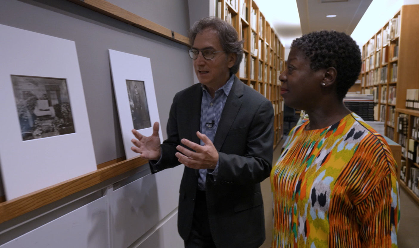 The curators Jeff Rosenheim and Thelma Golden stand before a series of photographs by the renowned Harlem Renaissance photographer James Van Der Zee.