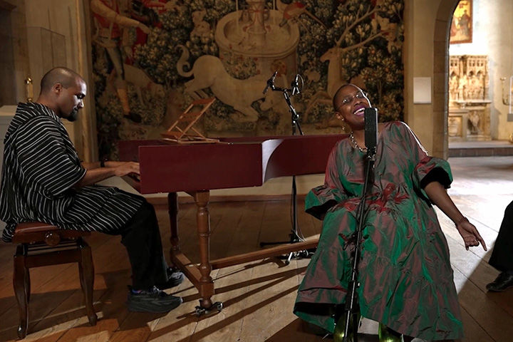 Cécile McLorin performing at The Met Cloisters, flanked by a pianist.