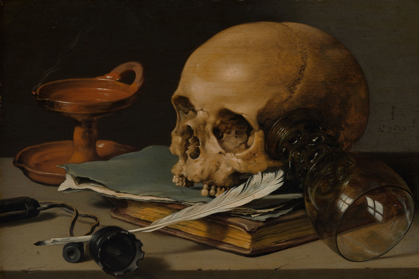A human skull missing its front teeth rests upon a book. An inkwell, quill, and glass cup have been turned over, and incense burns out nearby.