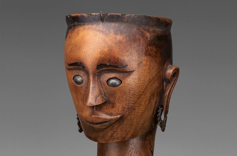 wood puppet head with a face carved in