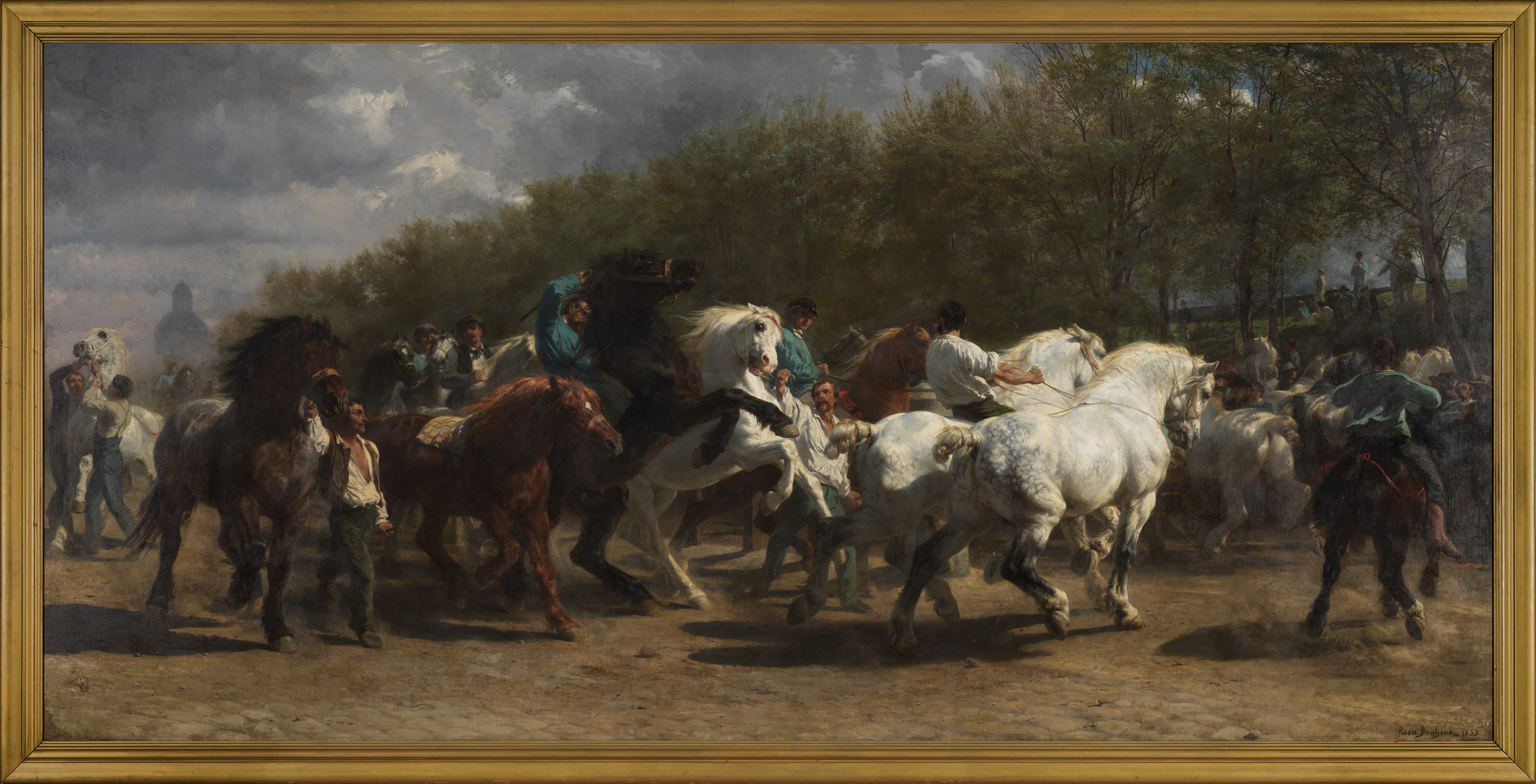 An oil painting depicting a gloomy afternoon with a procession of rowdy horses being led by men on foot and horseback as they round a corner on a dusty dirt road into a park space with onlookers in the distance. 