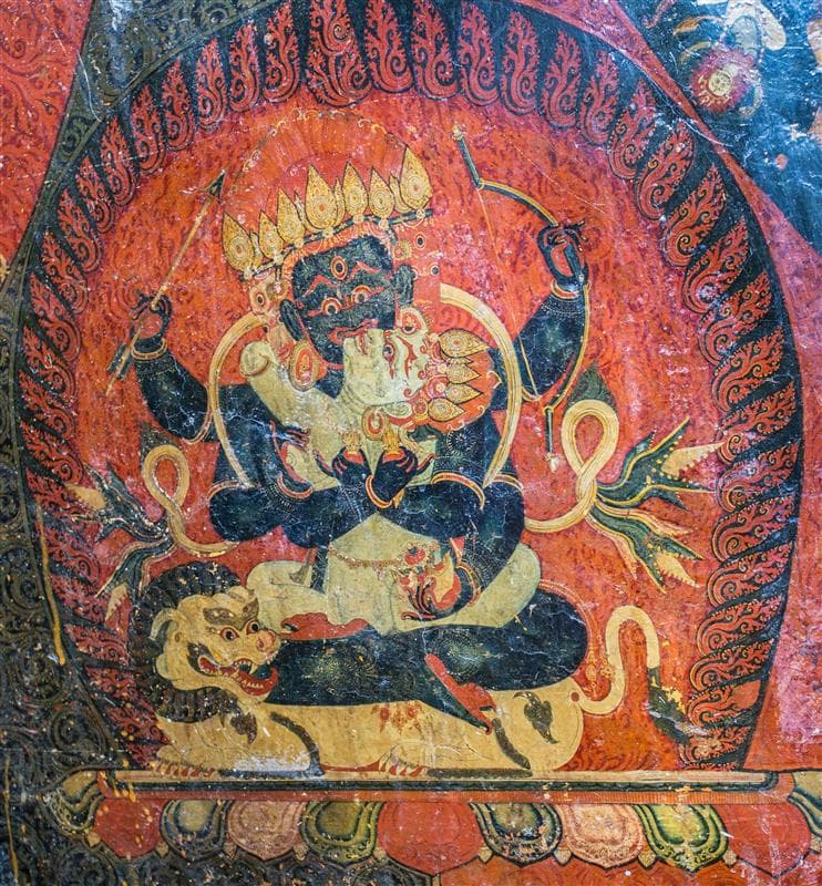 A red background with two deities depicted intertwined. One is holding a bow and arrow, and the other looks up to him. This is a zoomed-in selection from a larger object. 