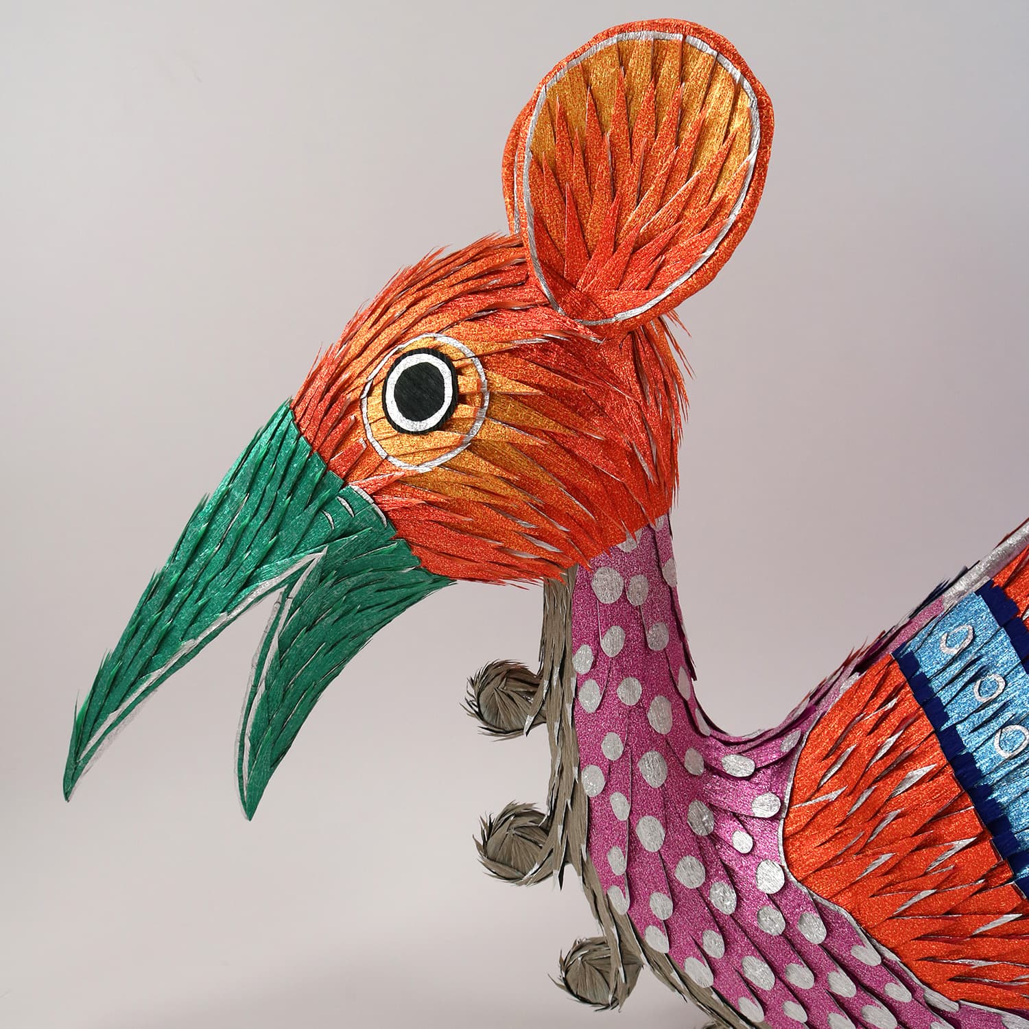 Close up of a colorful mythical bird piñata