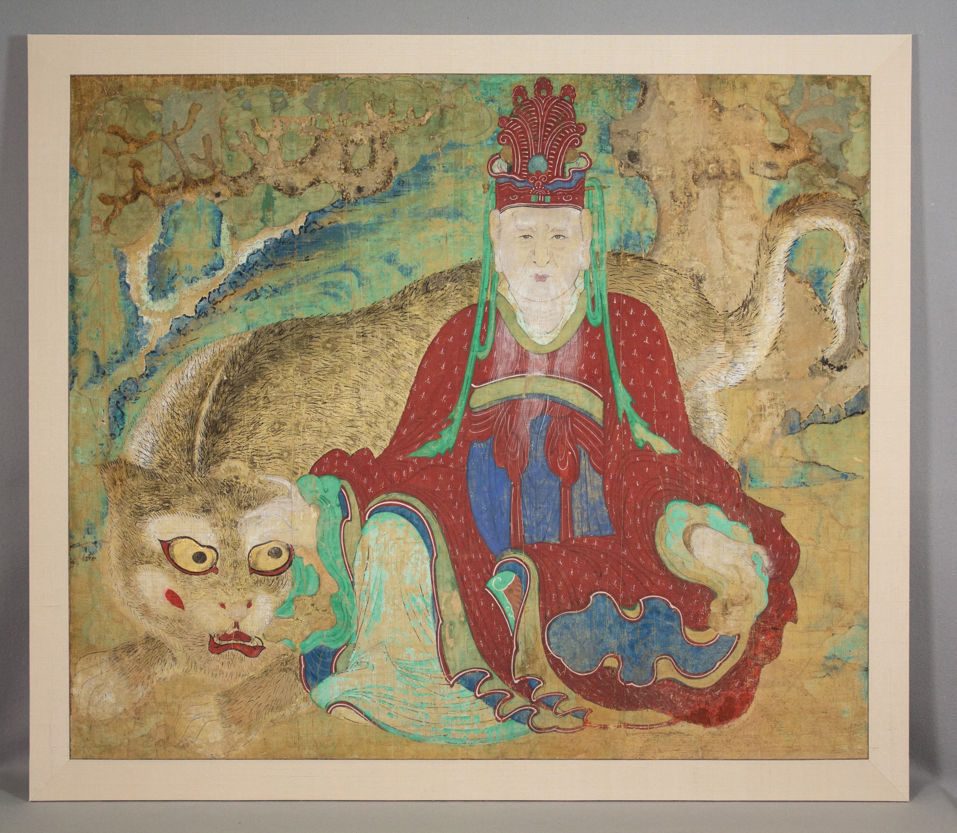 This colorful illustration depicts a person sitting peacefully cross legged on the floor wearing a red robe and headpiece. There is a large dragon behind them coming around their left side. 