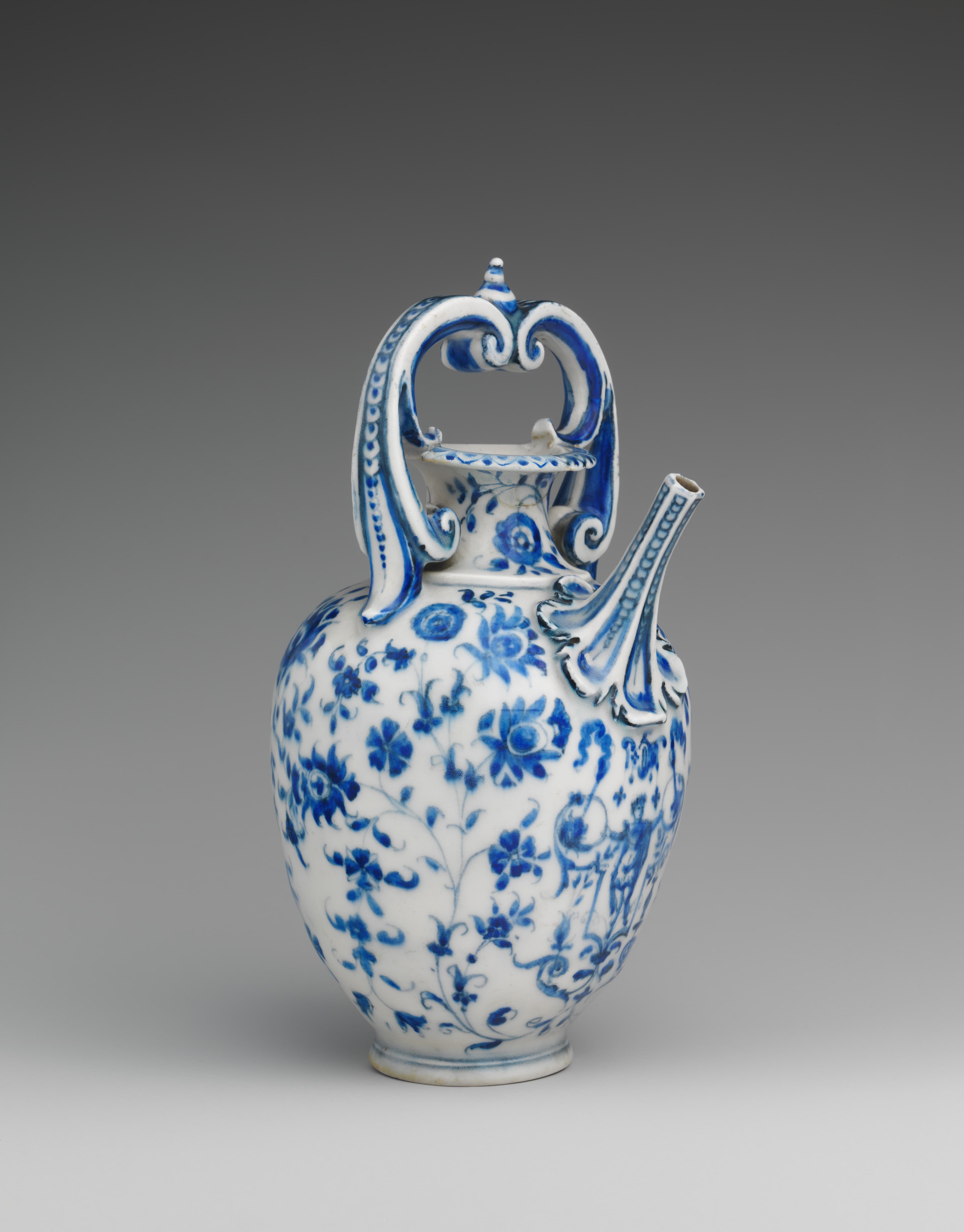 A detailed photograph of a white porcelain vessel decorated in underglaze blue flowers. 