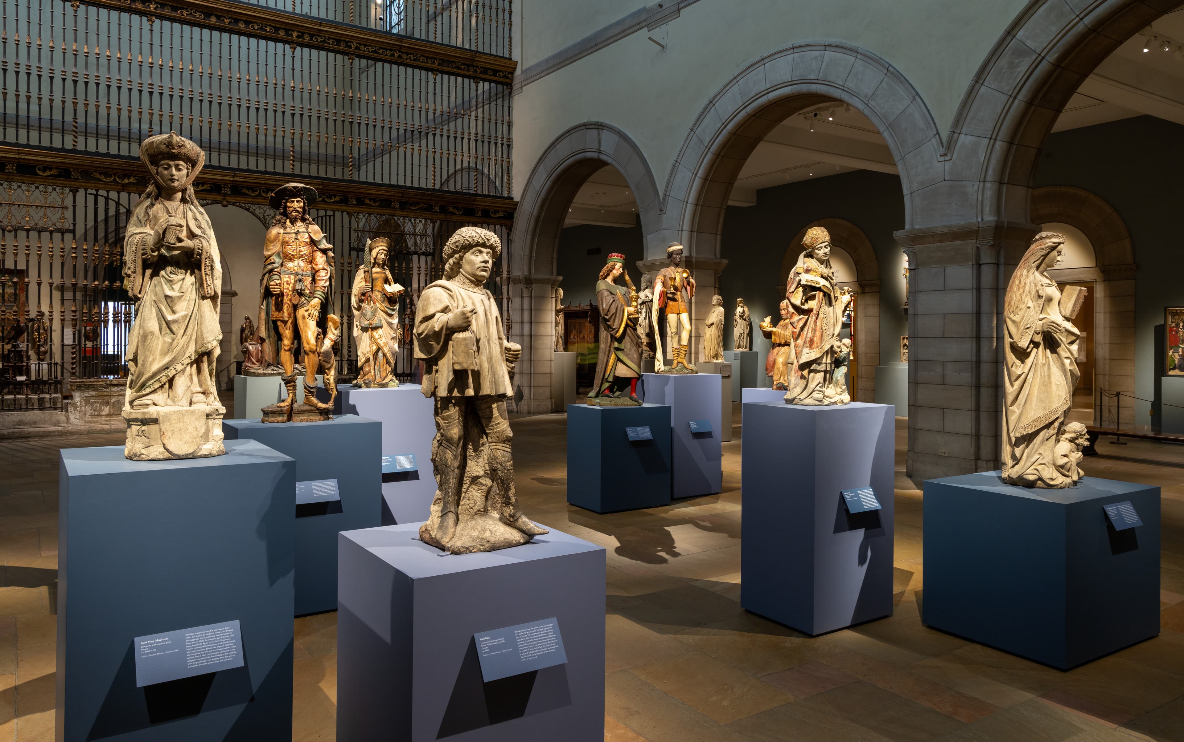 Medieval sculptures on pedestals in the The Met's galleries