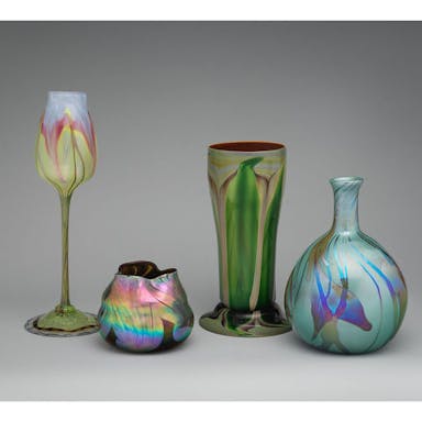 Photo of four colorful vases against grey background