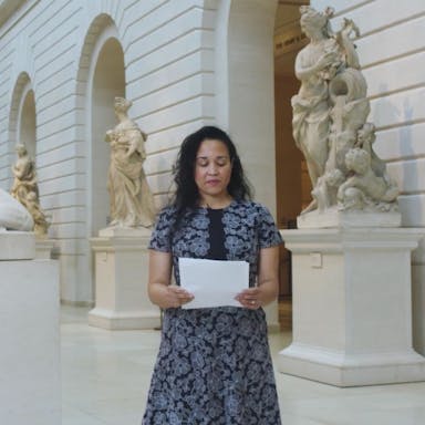 Poet Wendy S. Walters reading a poem in the European Sculpture and Decorative Arts galleries