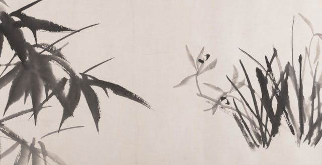 Silhouette of orchids and bamboo painted with black ink on a handscroll paper