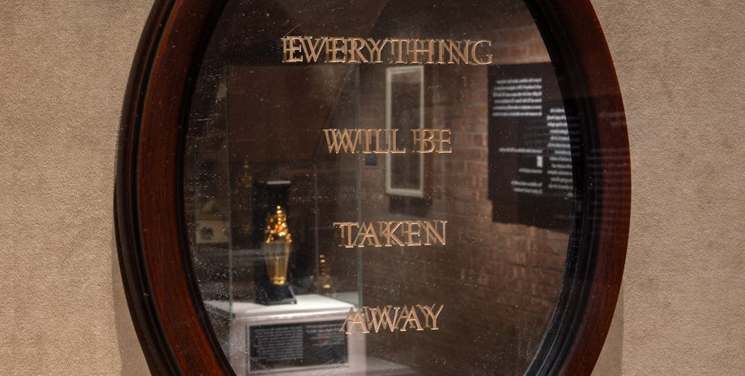 Reflective mirror that says EVERYTHING WILL BE TAKEN AWAY. 