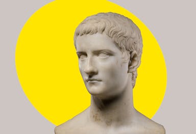 Marble portrait bust of Caligula, with a bright yellow ovular spotlight shape behind the figure in the background