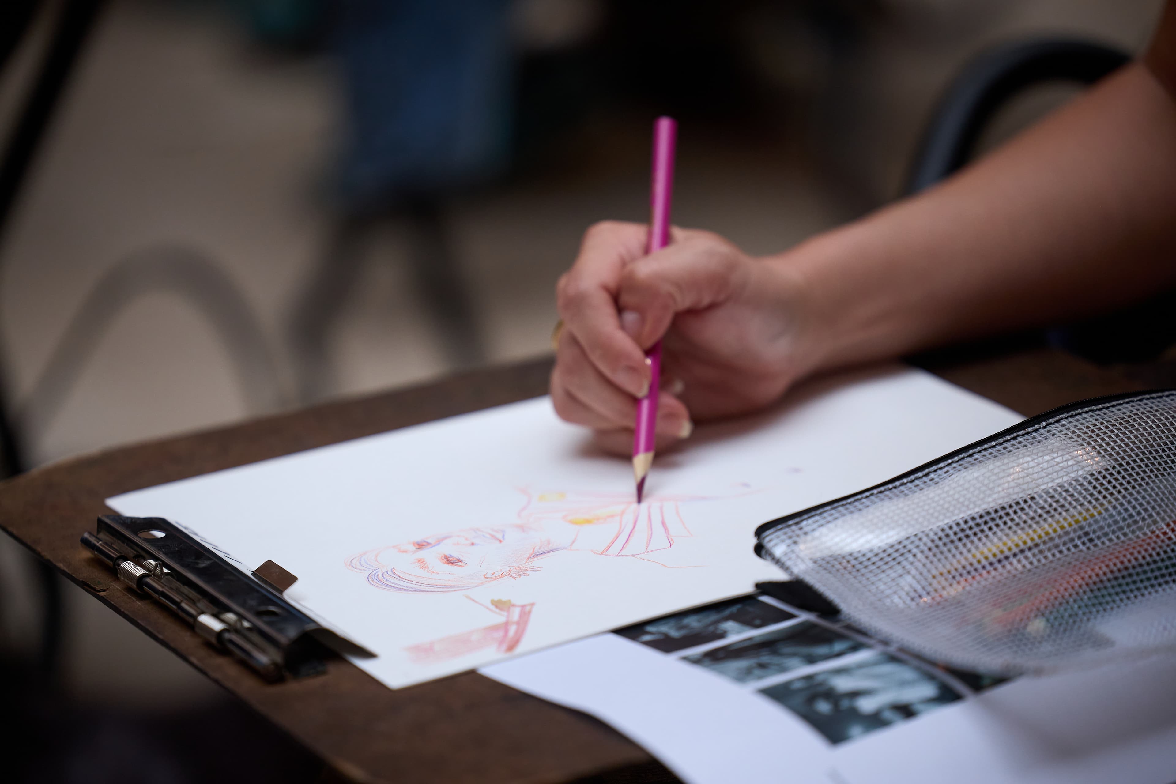 Hand of program participant drawing.