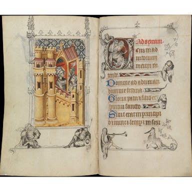 Book open to a spread with illustration of castle to the left and text on the right