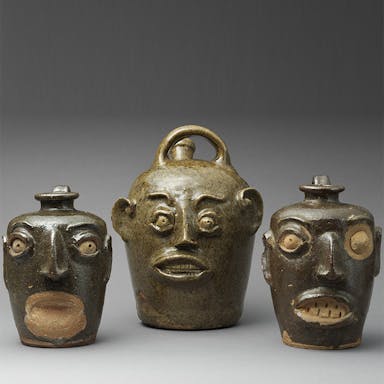 Three jugs with faces