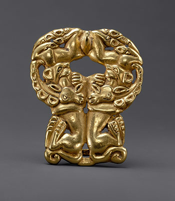 Belt buckle: paired felines attacking ibexes