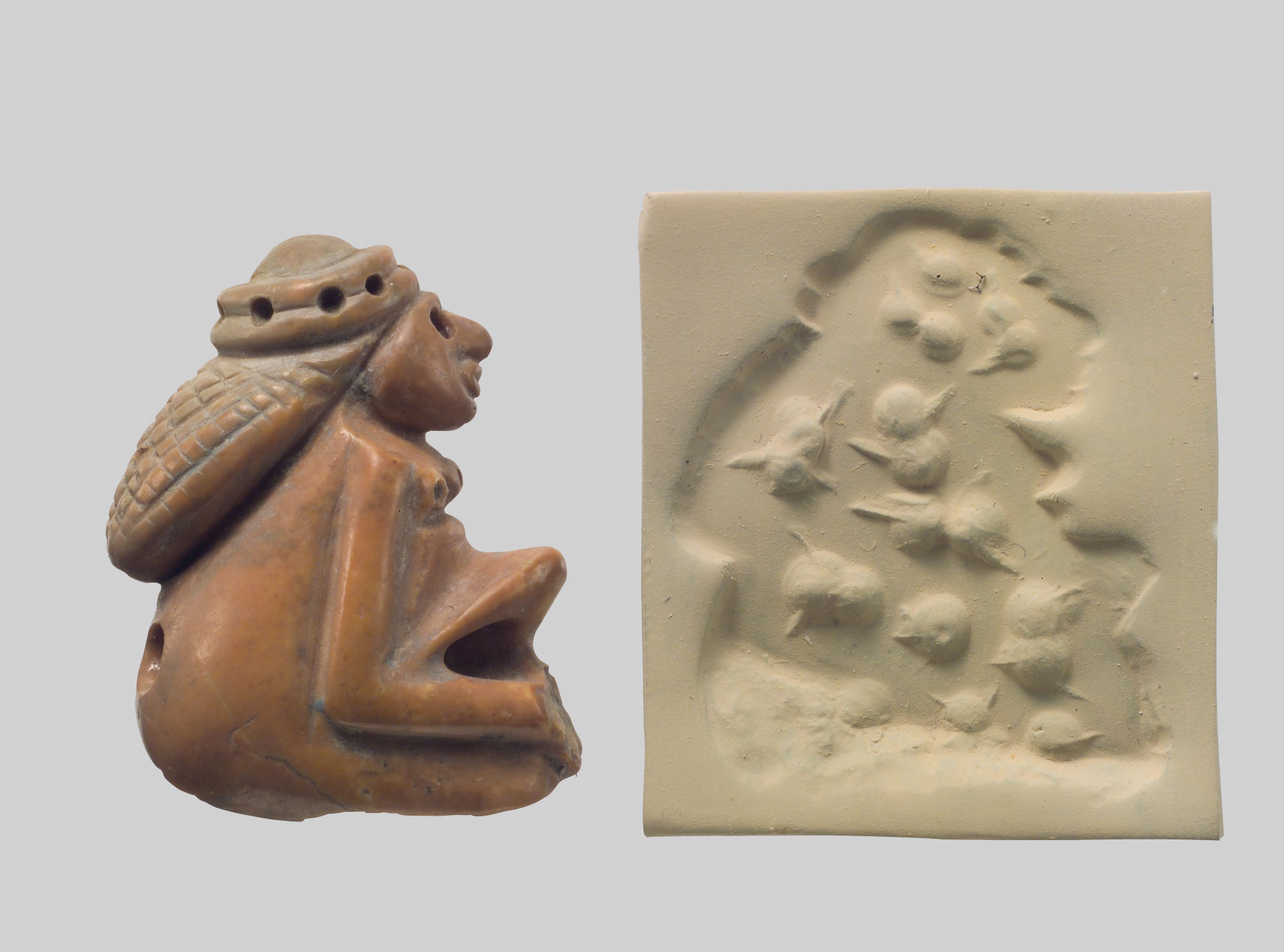 Seal amulet in the form of a seated female and modern impression